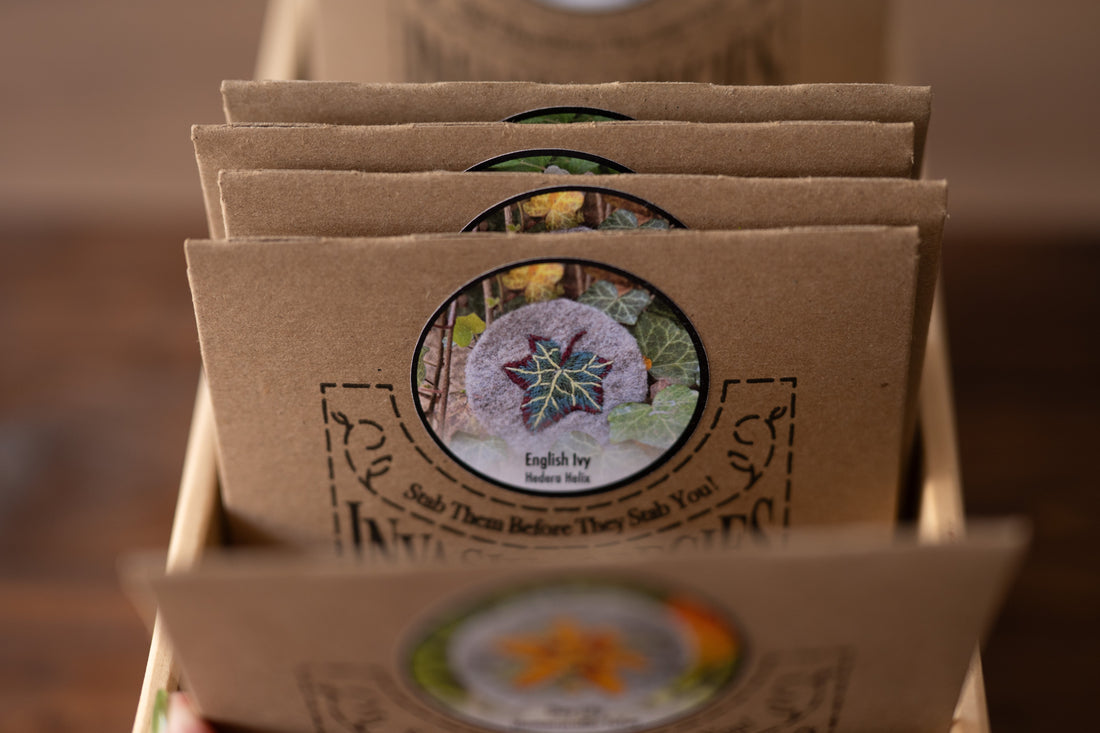 A close-up photo of embroidery kits in a wooden box on a wooden bench background